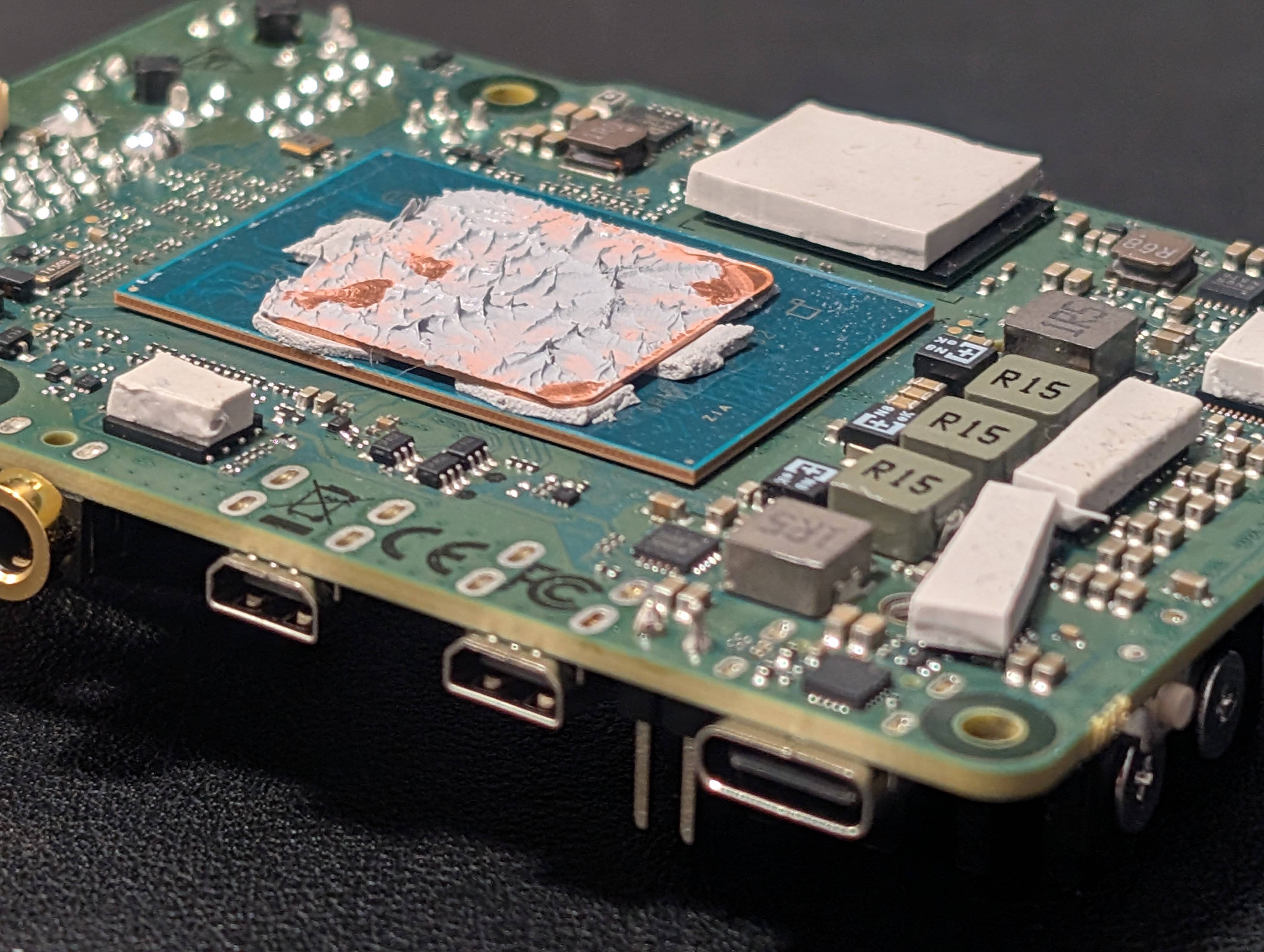 
With the 1mm copper shim installed on the "frame" and artic mx6 thermal compound applied between interfaces. 
Note the 2mm thermal pads applied on the various heat generating chips (ram, MOSFETs, voltage regulators etc.)